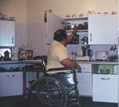 man in wheelchair in kitchen